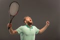 Handsome young man in polo shirt holding tennis Royalty Free Stock Photo