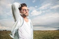 Handsome young man posing while fixing his hair. Royalty Free Stock Photo