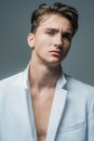 Handsome young man posing on grey. Portrait of satisfied man. Close up face of fashionable male model. Royalty Free Stock Photo