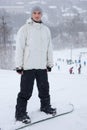 Handsome young man posing on his snowboard Royalty Free Stock Photo