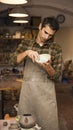 Handsome young man posing in pottery workshop Royalty Free Stock Photo