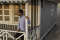 An handsome young man posing under the porch of a typical cottage house along the beach at Costa da Caparica, wearing sunglasses Royalty Free Stock Photo