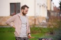 Handsome young man preparing barbecue for friends in the backyard Royalty Free Stock Photo