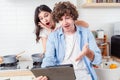 Handsome young man and pretty girlfriend looking at digital computer tablet screen Royalty Free Stock Photo