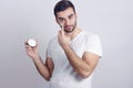 Handsome young man putting face cream Royalty Free Stock Photo