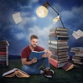 Handsome young man reading and flying books in park