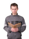 Handsome young man reading an old book on white background Royalty Free Stock Photo