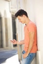 Handsome young man reading text on mobile phone Royalty Free Stock Photo