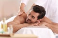 Handsome young man receiving back massage Royalty Free Stock Photo