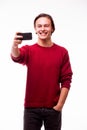 Handsome young man in red sweater holding camera and making selfie Royalty Free Stock Photo