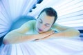 Handsome young man relaxing in a modern solarium Royalty Free Stock Photo