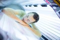Handsome young man relaxing in a solarium Royalty Free Stock Photo