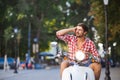 Handsome young man riding a vintage scooter Royalty Free Stock Photo