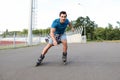 Handsome young man roller skating outdoors. Royalty Free Stock Photo