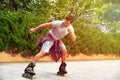 Handsome young man roller skating on sunny day Royalty Free Stock Photo