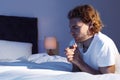 Handsome young man saying bedtime prayer in dark room Royalty Free Stock Photo