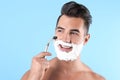 Handsome young man shaving Royalty Free Stock Photo