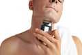 Handsome young man shaving face with electric razor on white background Royalty Free Stock Photo