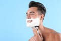 Handsome young man shaving Royalty Free Stock Photo