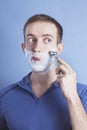 Handsome young man shaving Royalty Free Stock Photo