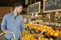 Handsome young man shopping for fruits in market