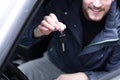 Handsome young man showing the key of new car Royalty Free Stock Photo
