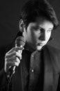 Handsome young man singer with microphone Elvis Royalty Free Stock Photo