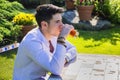 Handsome young man sitting alone at table outside Royalty Free Stock Photo