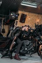 handsome young man sitting on bike with electric guitar Royalty Free Stock Photo