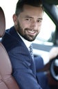 Handsome young man sitting in the front seat of a car looking at the camera Royalty Free Stock Photo