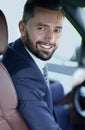 Handsome young man sitting in the front seat of a car looking at the camera Royalty Free Stock Photo