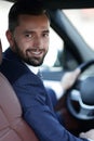 Handsome young man sitting in the front seat of a car looking at the camera Royalty Free Stock Photo