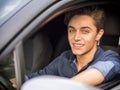 Handsome young man sitting in his car, looking at camera Royalty Free Stock Photo