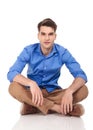 Handsome young man sitting with his legs crossed Royalty Free Stock Photo
