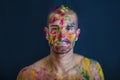 Handsome young man with skin all painted with Holi colors Royalty Free Stock Photo