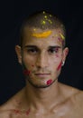 Handsome young man with skin all painted with Holi Royalty Free Stock Photo