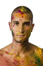 Handsome young man with skin all painted with Holi Royalty Free Stock Photo