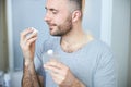 Handsome young man smelling perfume at home Royalty Free Stock Photo