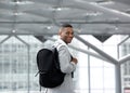 Handsome young man smiling with bag at airport Royalty Free Stock Photo