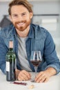 Handsome young man smiling and holding glass red wine Royalty Free Stock Photo