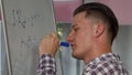 Handsome young man solving math problem on whiteboard Royalty Free Stock Photo