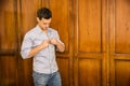 Handsome young man standing against wardrobe Royalty Free Stock Photo