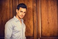 Handsome young man standing against wardrobe Royalty Free Stock Photo