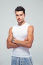 Handsome young man standing with arms folded