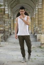 Handsome young man standing outdoors under old colonnade Royalty Free Stock Photo