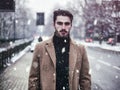 Young man in snowy city