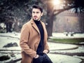 Young man in snowy city in Italy