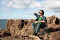 Handsome Young Man Sunbathing On The Beach Rocks Near Ocean Royalty Free Stock Photo