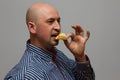 A handsome young man in a sweater eating chips Royalty Free Stock Photo