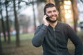 Handsome young man talking on his phone in an urban area Royalty Free Stock Photo